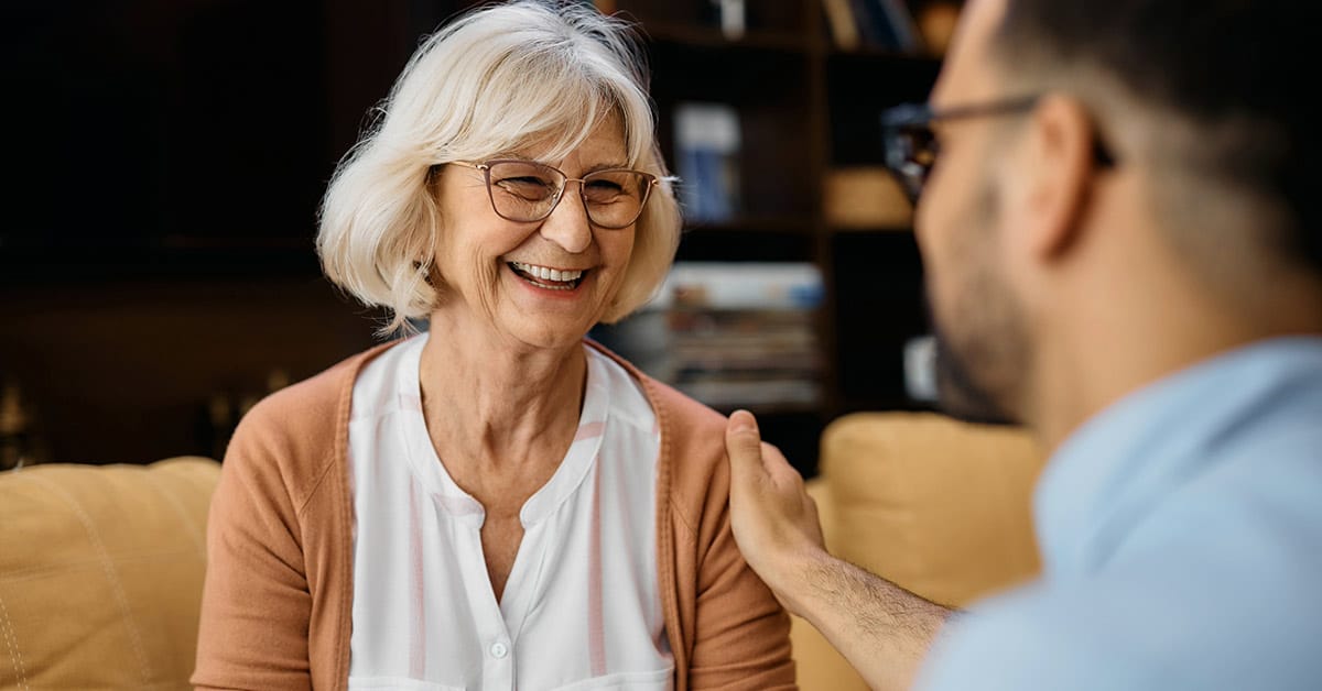 Smiling elderly woman and caretaker