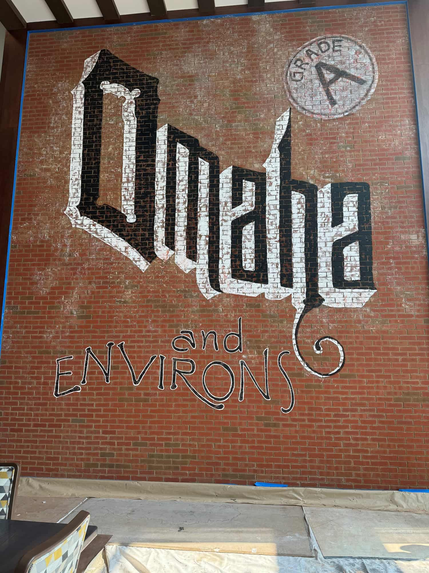 Brick wall painted with the words Omaha and Environs